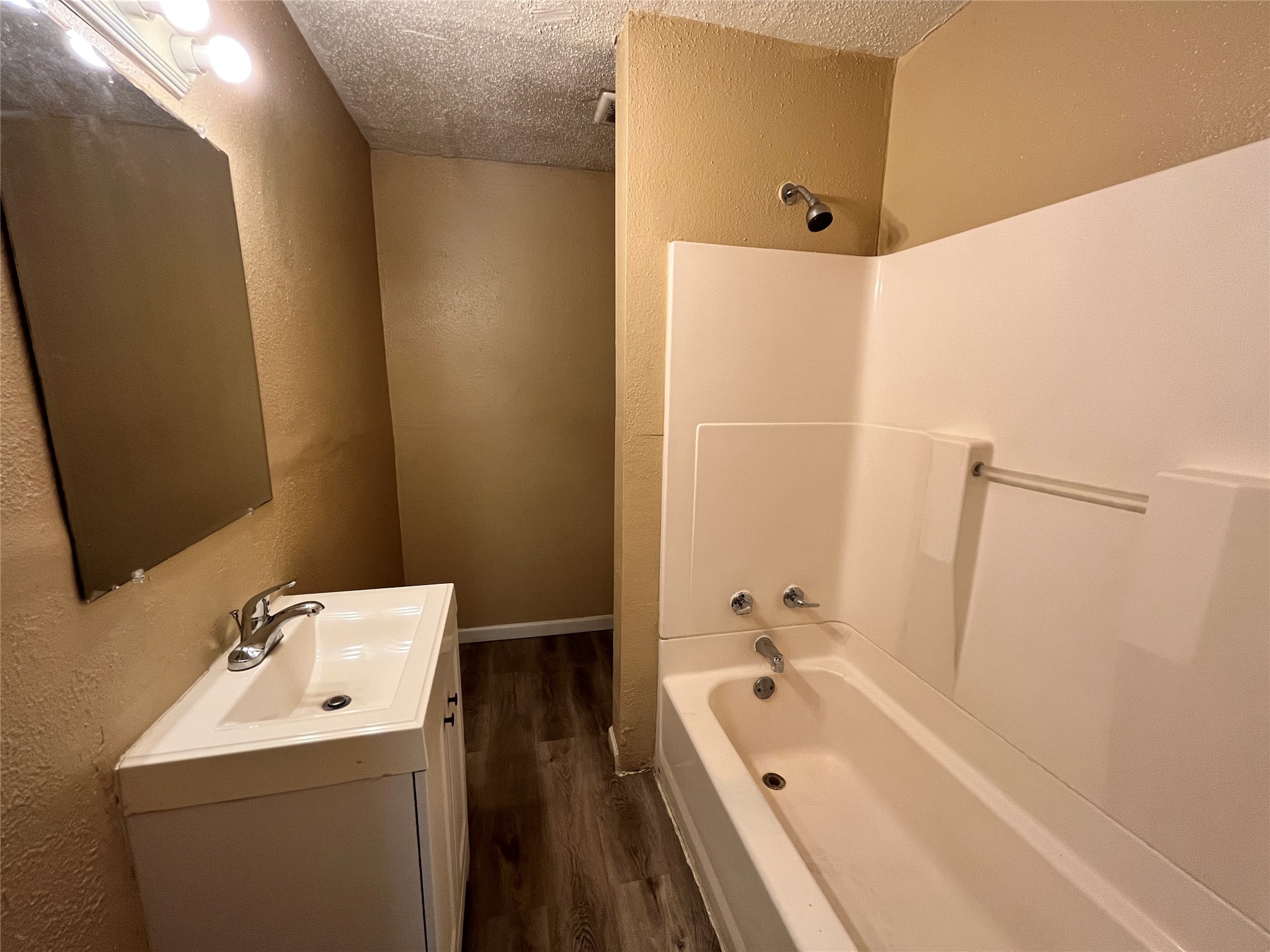 10235 Algiers Road, Unit 2 Houston, TX 77041 - Photo 7 of 12 a bathroom with a tub sink and mirror