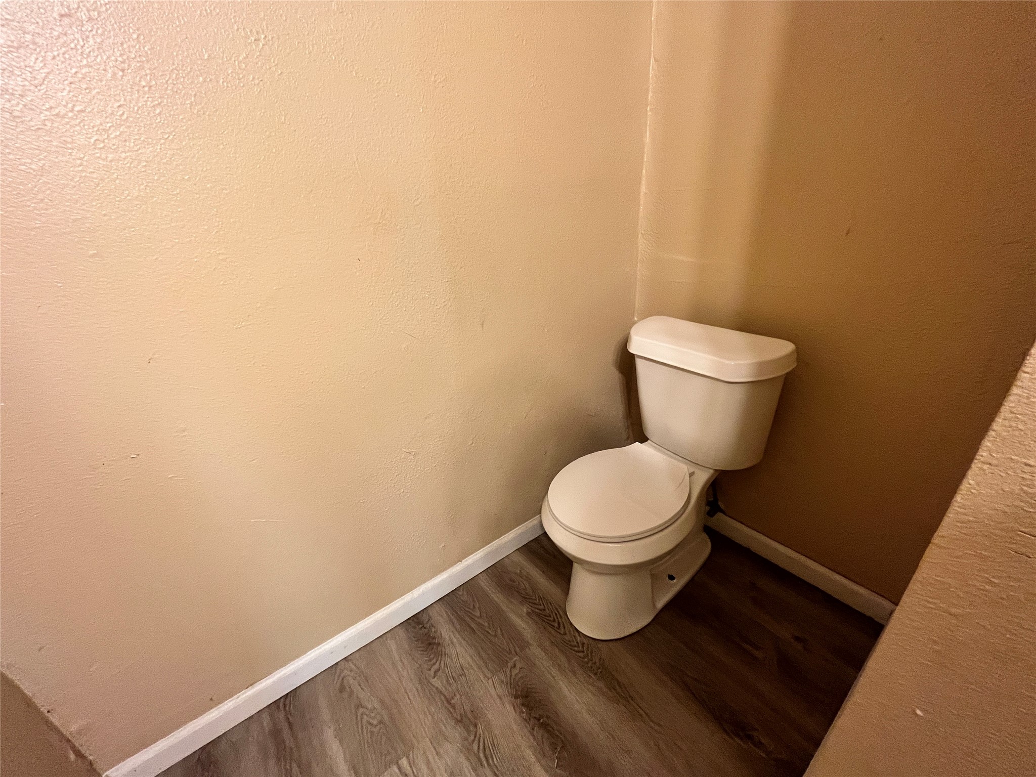 10235 Algiers Road, Unit 2 Houston, TX 77041 - Photo 8 of 12 a white toilet sitting next to a white wall