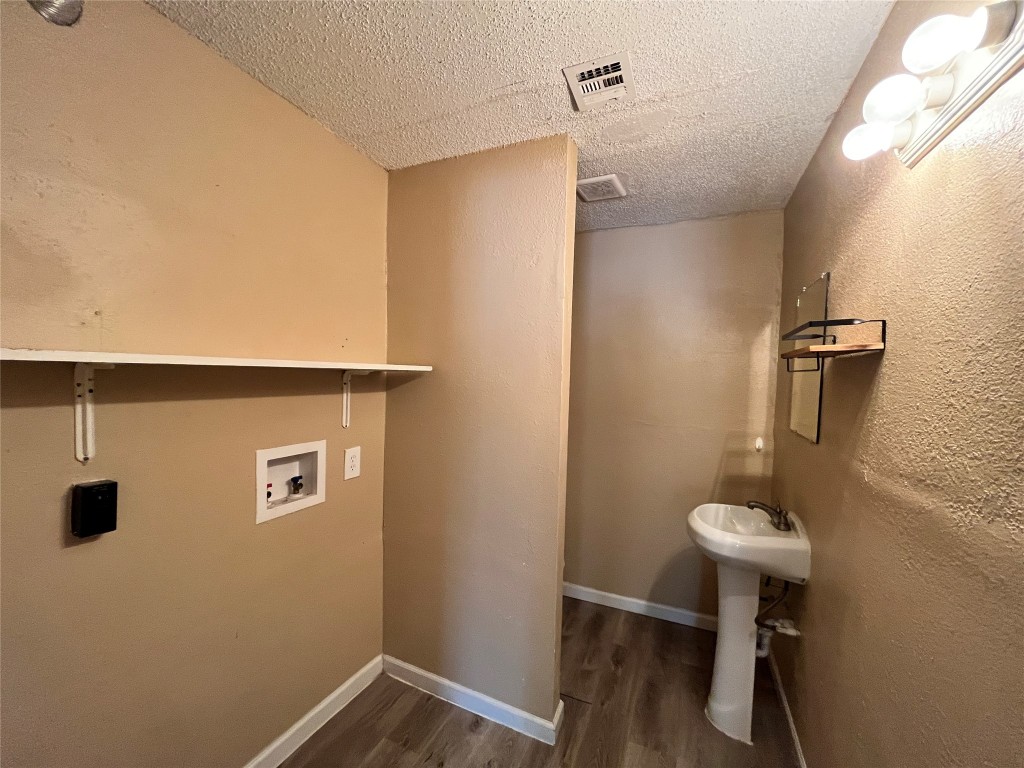 10235 Algiers Road, Unit 2 Houston, TX 77041 - Photo 10 of 12 a bathroom with a sink a mirror and a toilet
