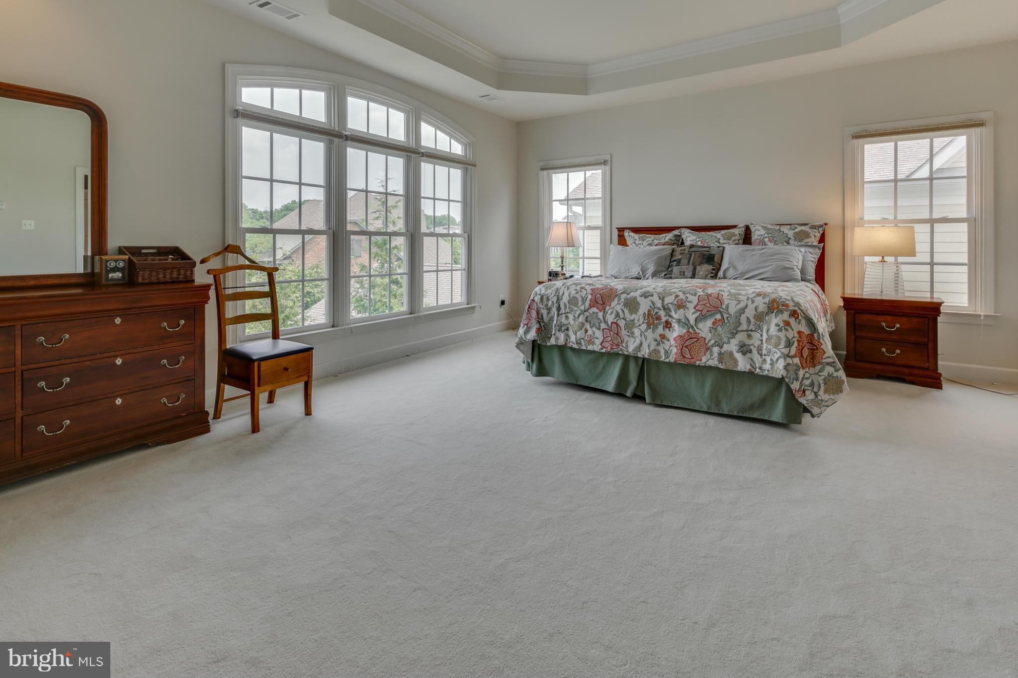 7706 Elmwood Road Fulton, MD 20759 - Photo 11 of 30 a bedroom with a bed and a dresser next to a window