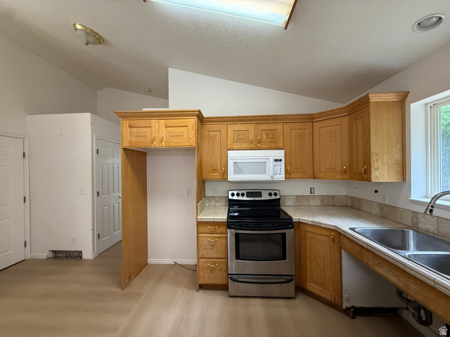 838 East Mountain Road Logan, UT 84321 - Photo 11 of 37 Kitchen featuring wood cabinetry, stainless steel range, built-in microwave, and a double basin sink