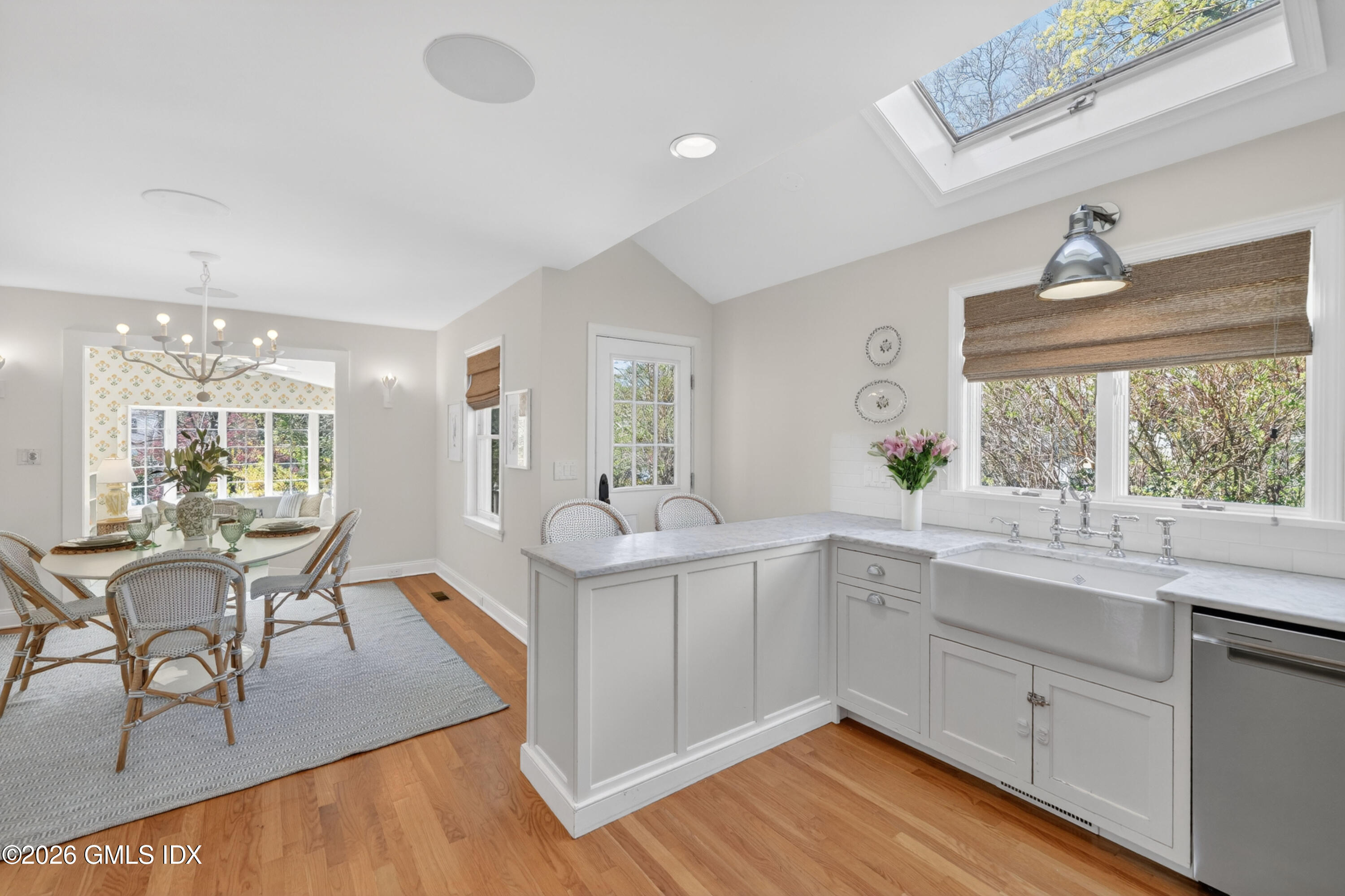 20 Ridge Road Cos Cob, CT 06807 - Photo 14 of 36 a kitchen with a sink cabinets and dining table chair