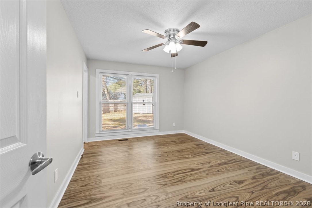 3305 Hunting Bay Drive Spring Lake, NC 28390 - Photo 16 of 27 a view of an empty room with wooden floor and a window