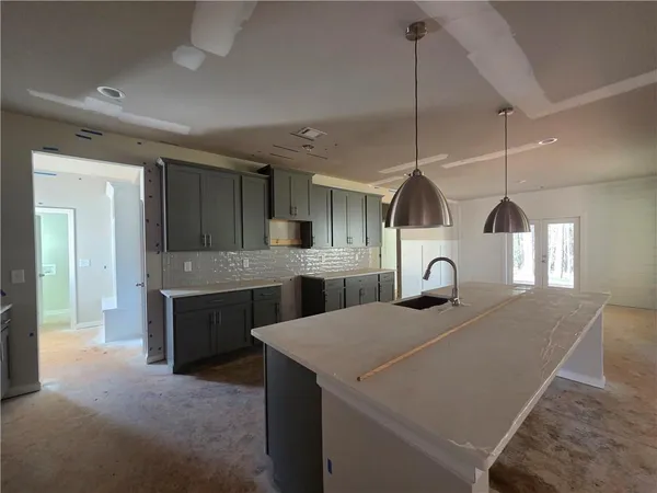 a kitchen with a sink a counter space and appliances