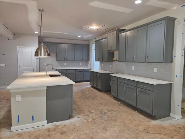 a kitchen with a sink cabinets and window