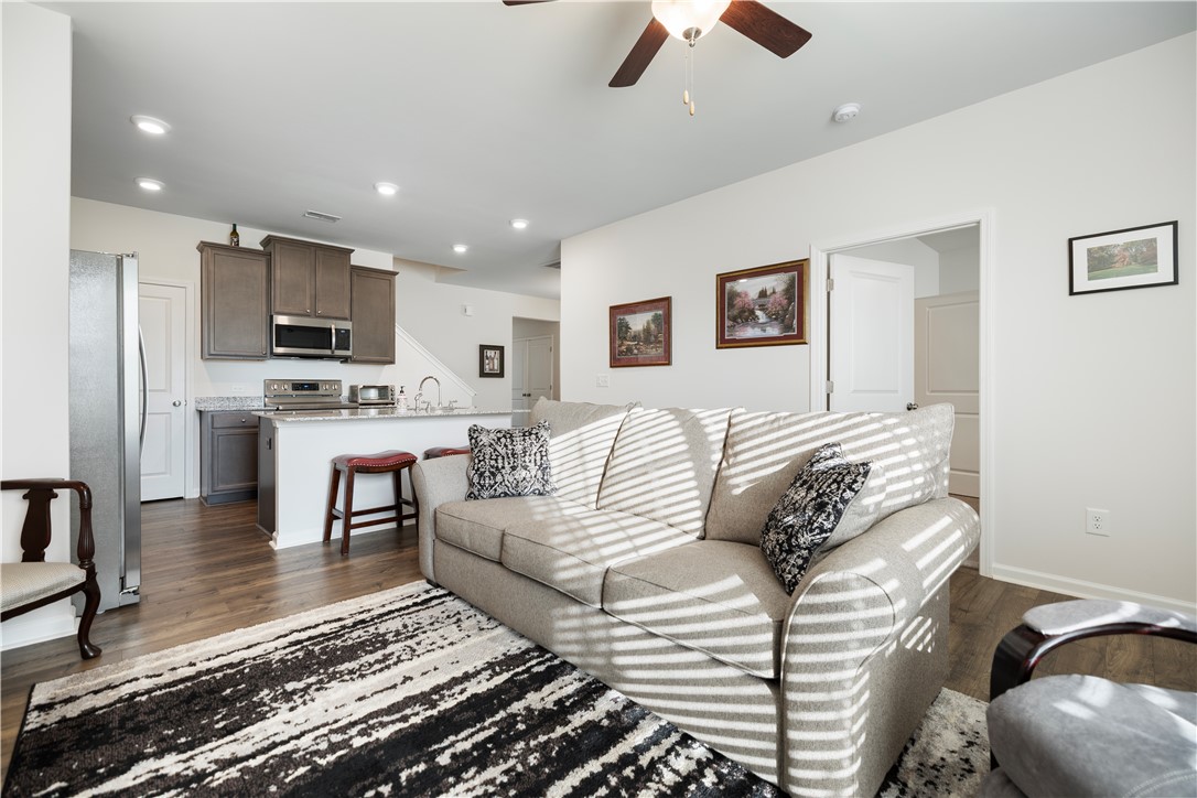 104 Village Main Anderson, SC 29621 - Photo 3 of 32 This inviting living space seamlessly connects to a modern kitchen, perfect for daily living.