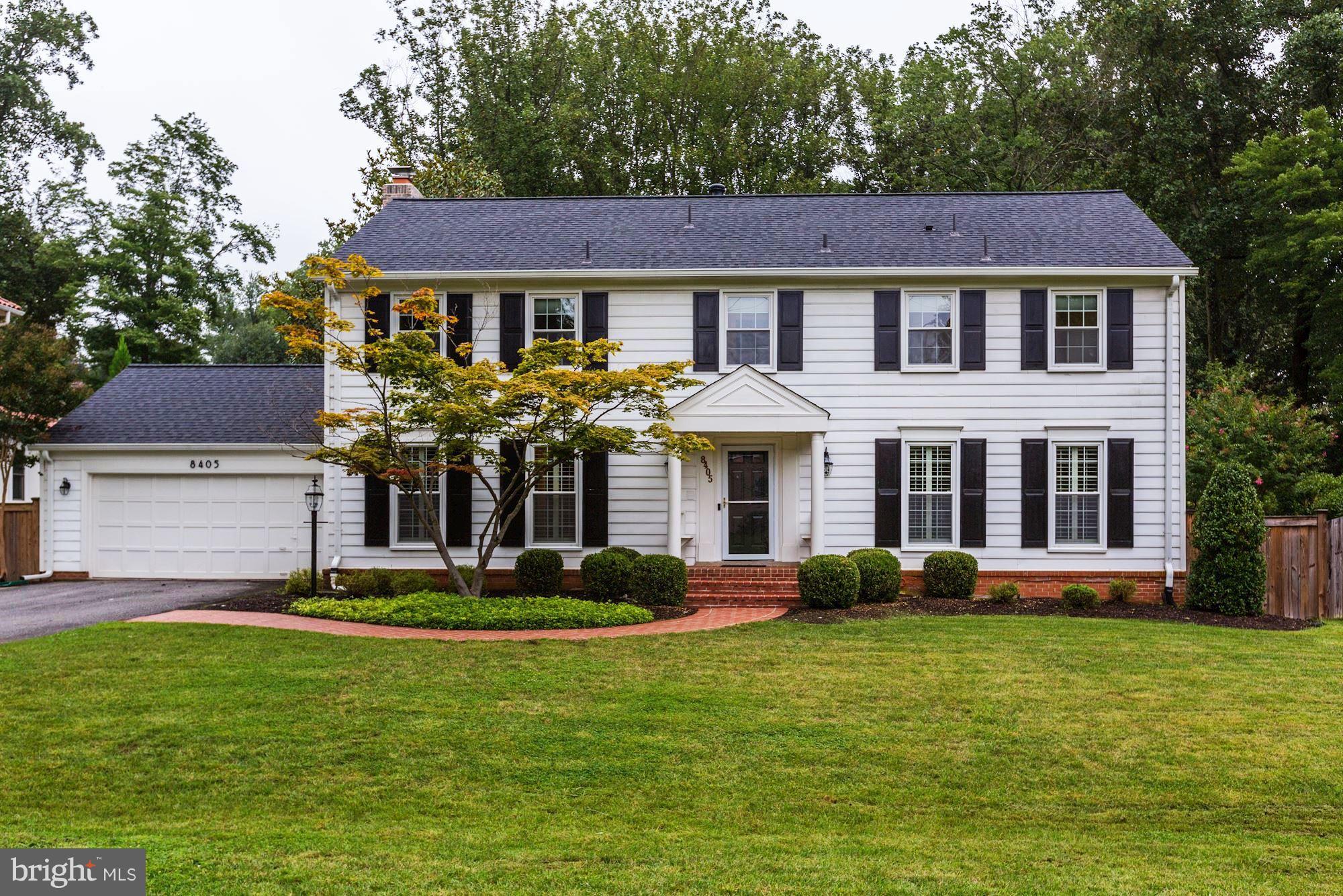 8405 Kingsgate Road Potomac, MD 20854 - Photo 1 of 30 a front view of a house with a garden and plants
