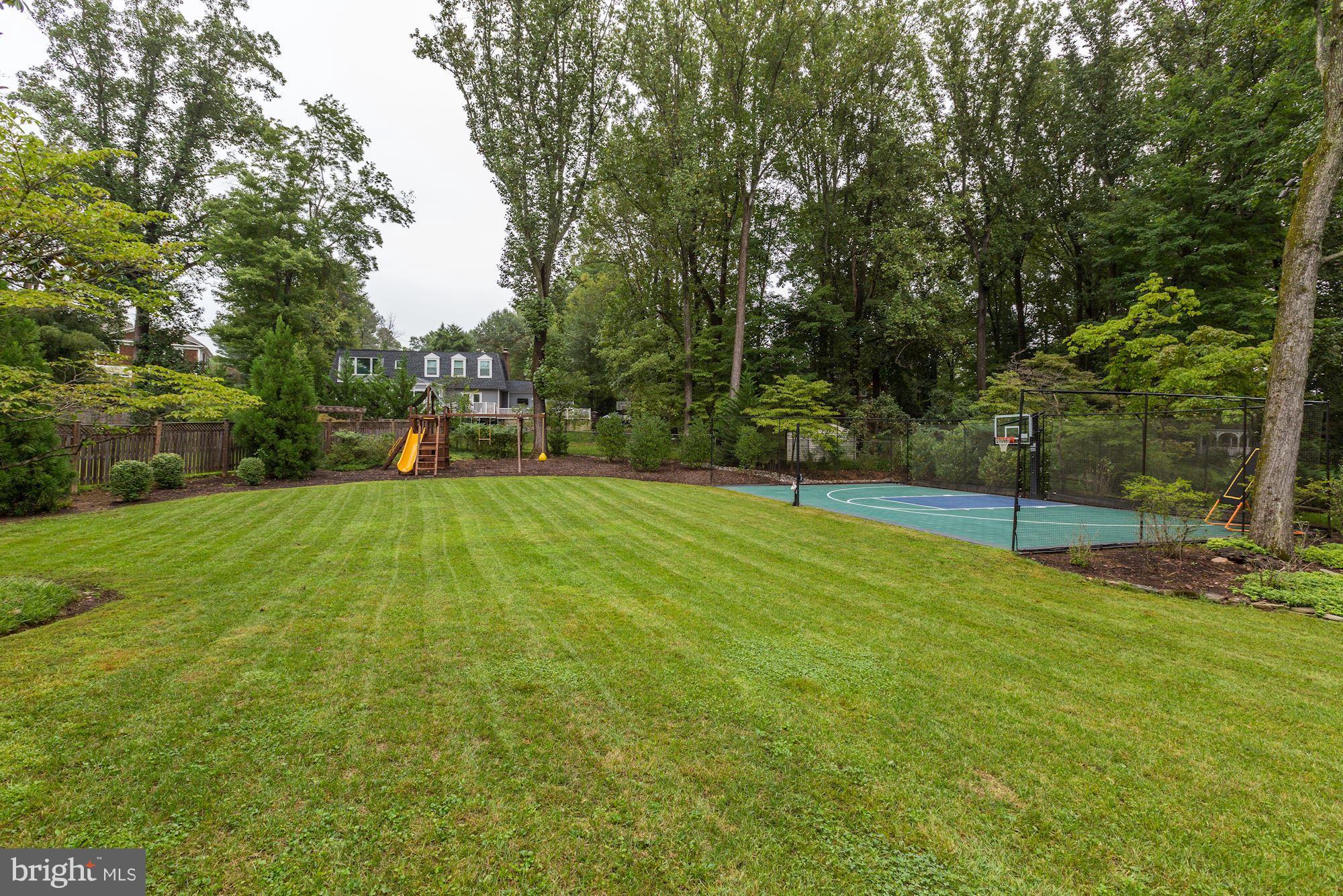 8405 Kingsgate Road Potomac, MD 20854 - Photo 13 of 30 a view of a backyard with green space