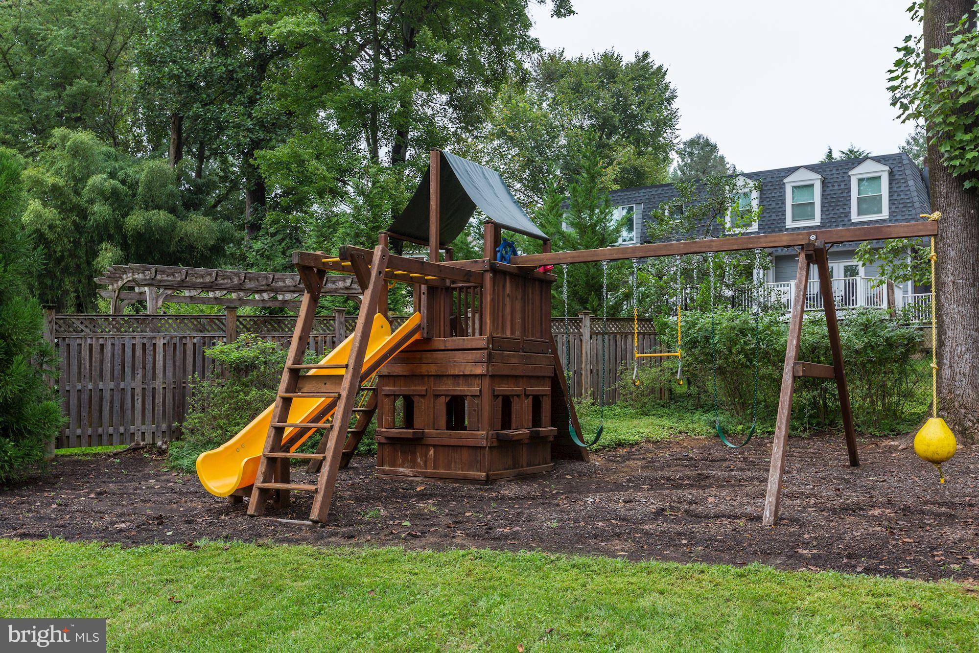8405 Kingsgate Road Potomac, MD 20854 - Photo 15 of 30 a view of a house with backyard and a slide