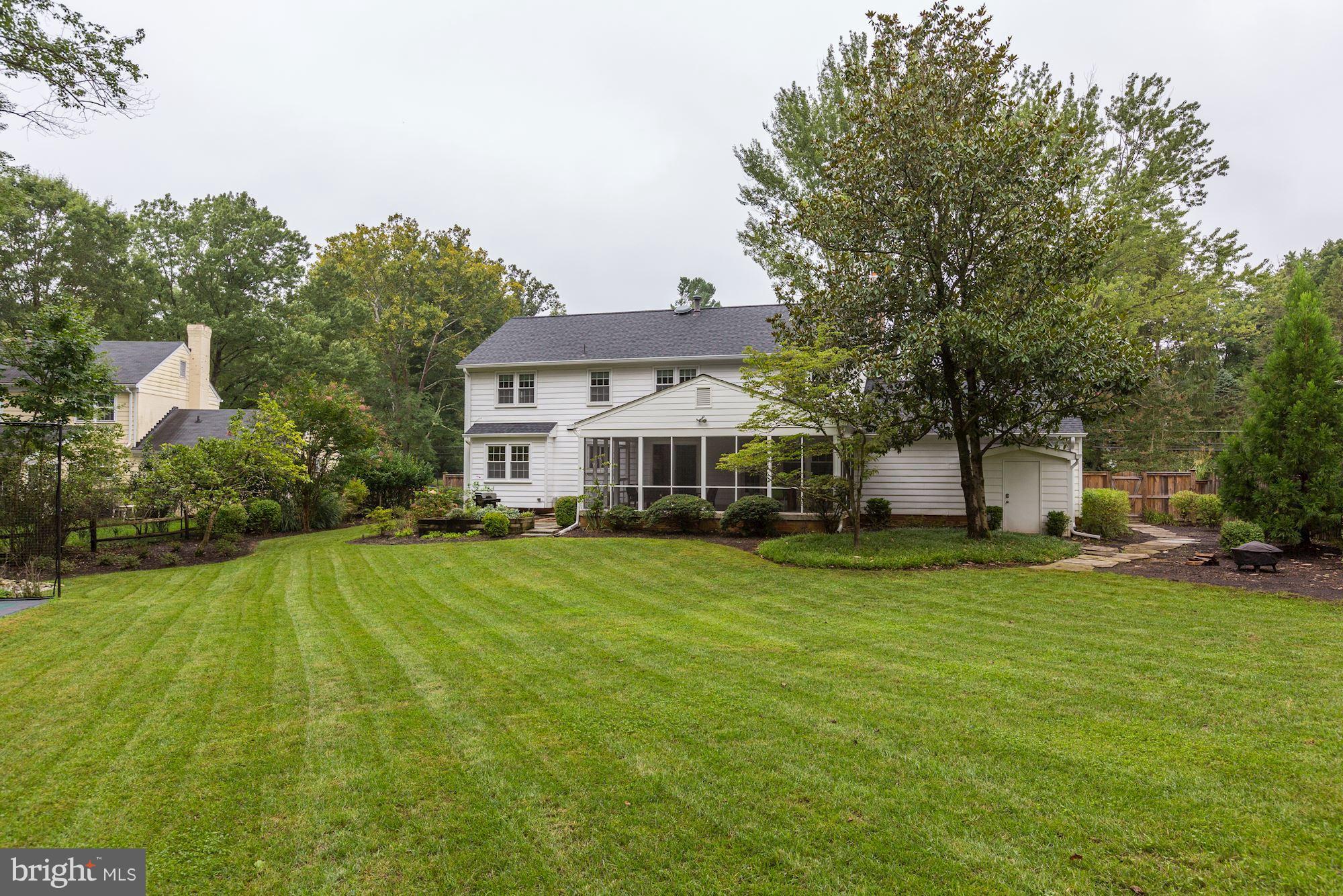 8405 Kingsgate Road Potomac, MD 20854 - Photo 16 of 30 a front view of a house with a yard
