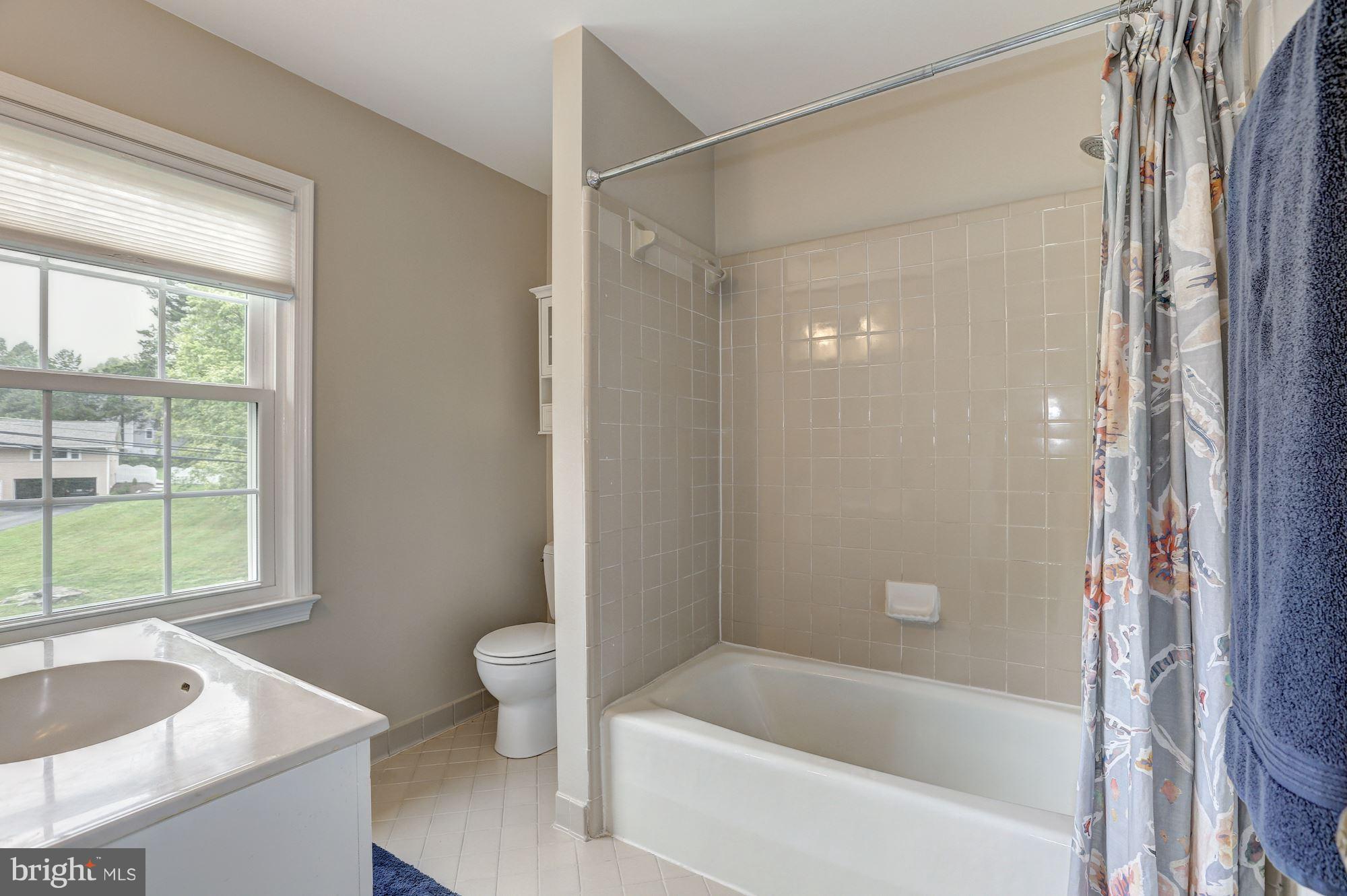 8405 Kingsgate Road Potomac, MD 20854 - Photo 21 of 30 a bathroom with a granite countertop tub sink and window