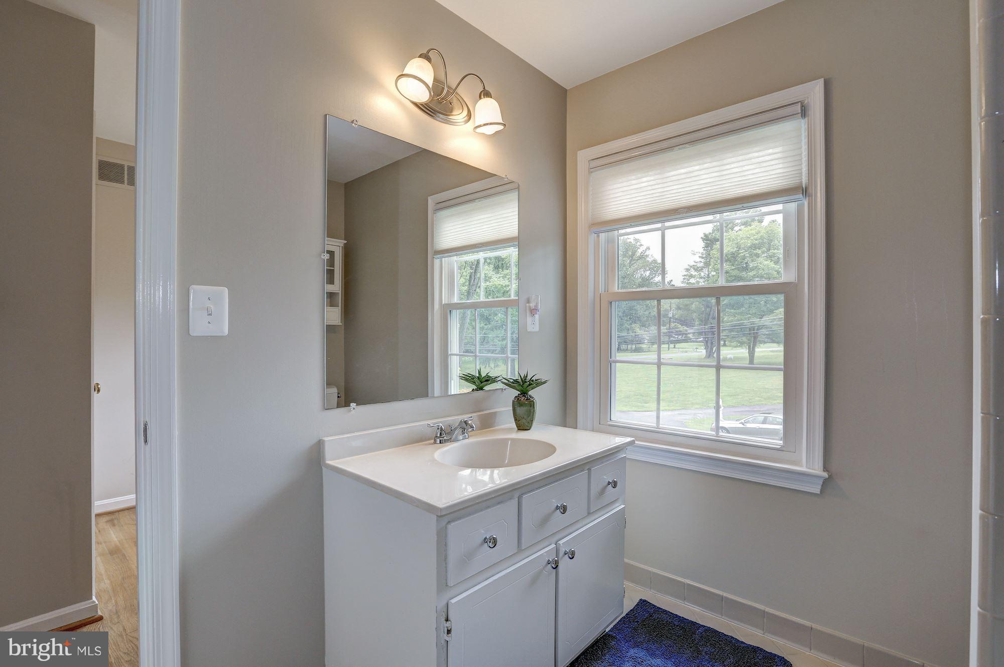 8405 Kingsgate Road Potomac, MD 20854 - Photo 22 of 30 a bathroom with a sink vanity and a mirror