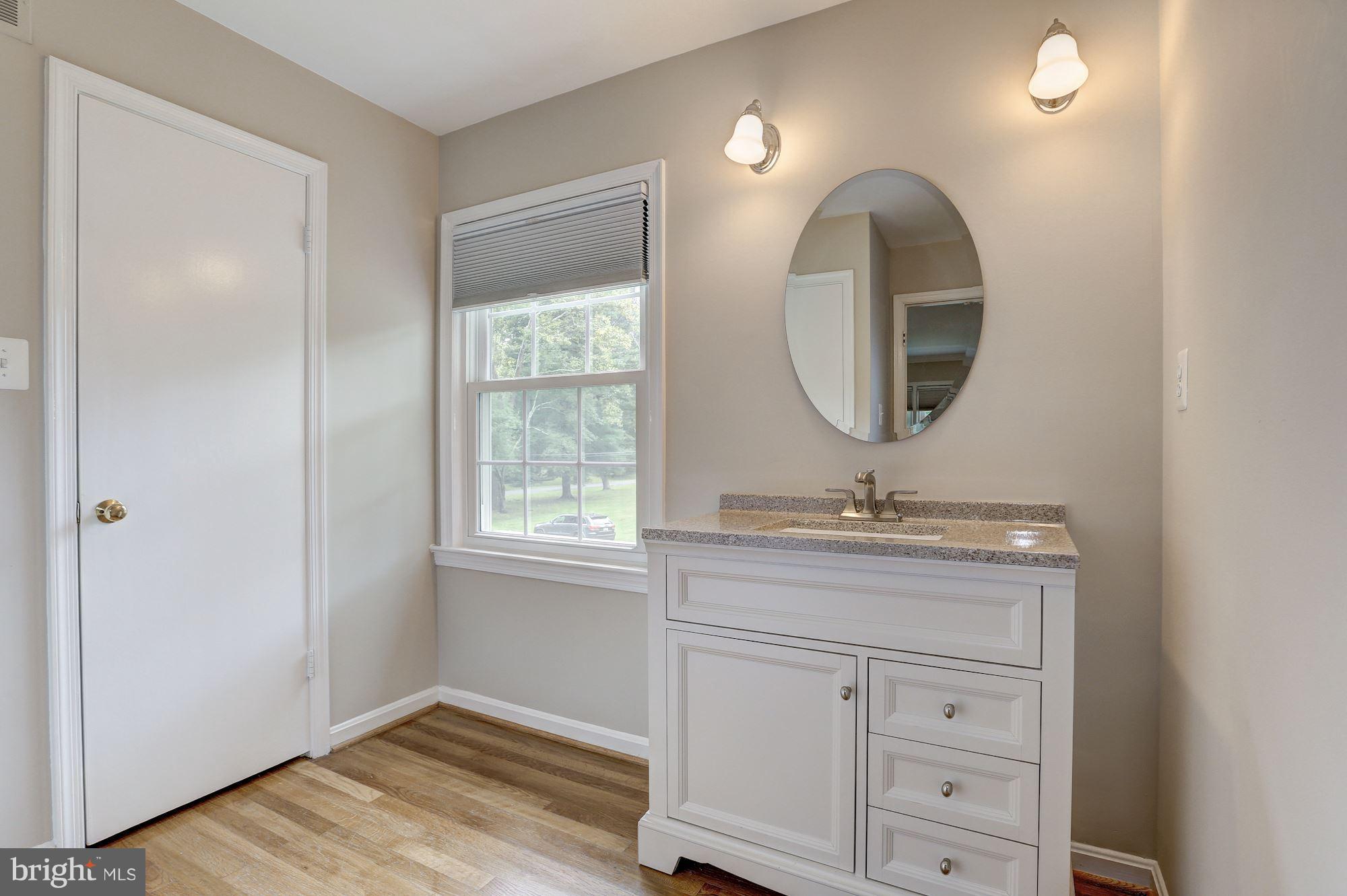 8405 Kingsgate Road Potomac, MD 20854 - Photo 23 of 30 a bathroom with a sink and a mirror