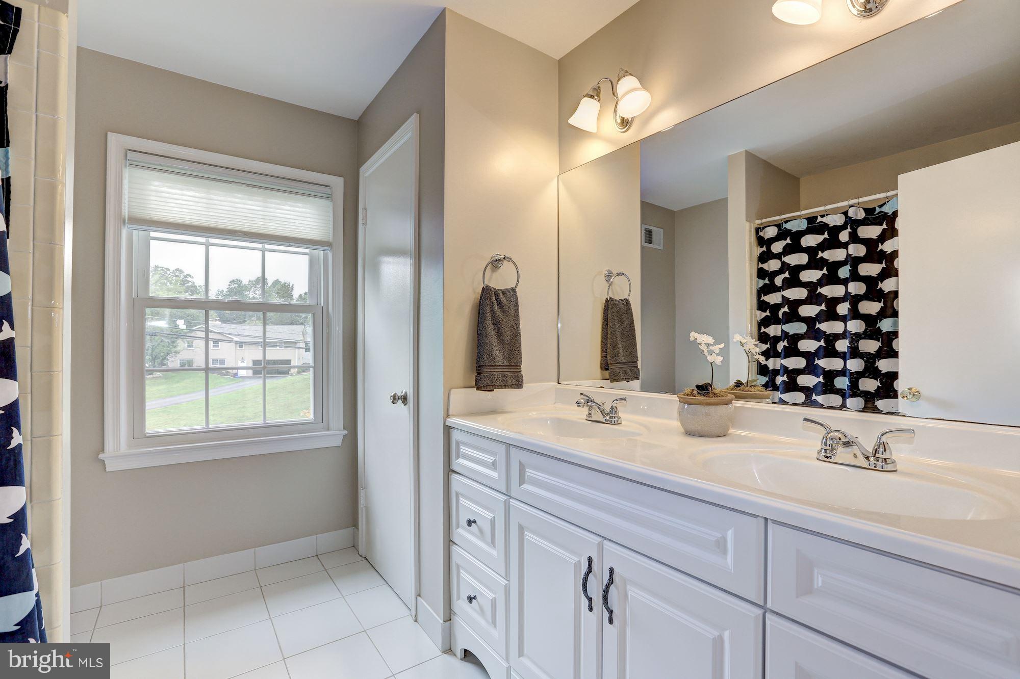 8405 Kingsgate Road Potomac, MD 20854 - Photo 24 of 30 a bathroom with a sink and a mirror