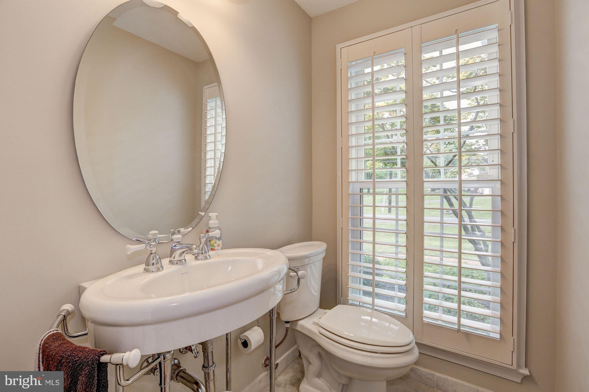 8405 Kingsgate Road Potomac, MD 20854 - Photo 30 of 30 a bathroom with a sink a toilet and a mirror