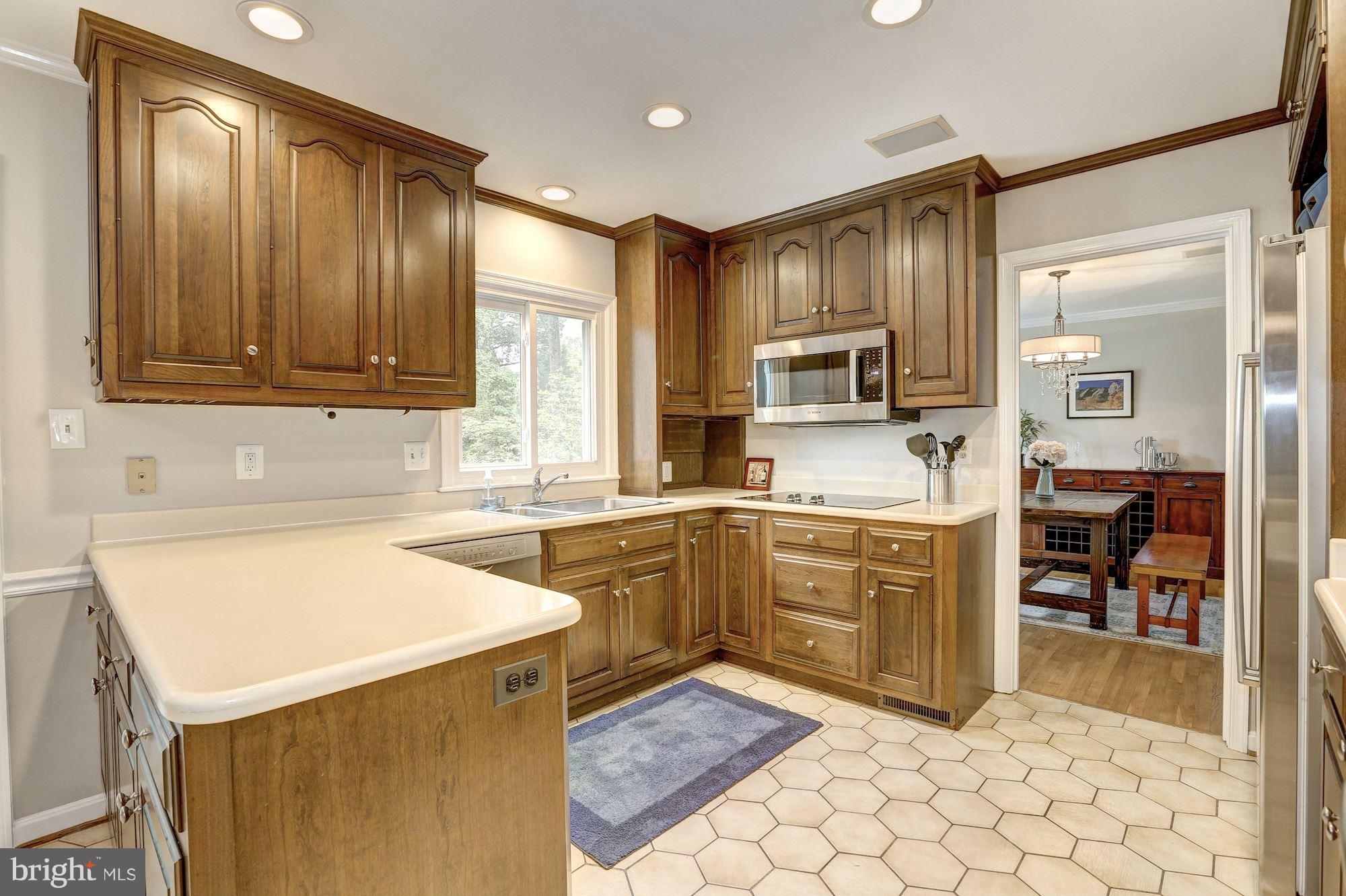 8405 Kingsgate Road Potomac, MD 20854 - Photo 4 of 30 a kitchen with cabinets appliances and a window