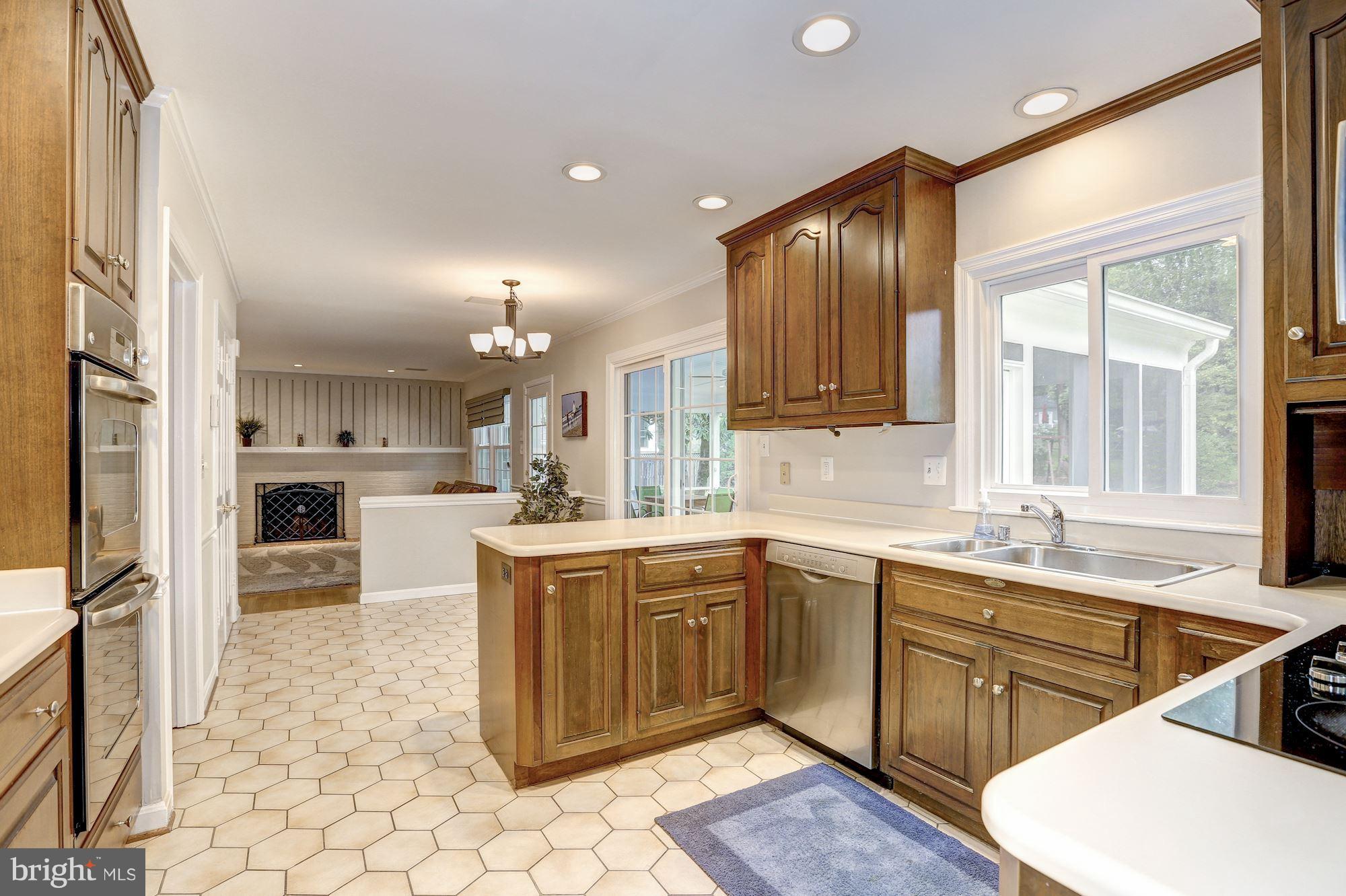8405 Kingsgate Road Potomac, MD 20854 - Photo 5 of 30 a kitchen with a sink stove and cabinets