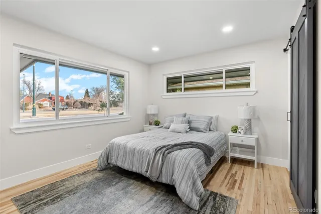 a bedroom with a bed and a large window