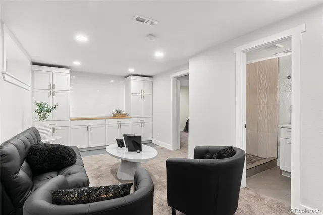 a living room with furniture and a potted plant