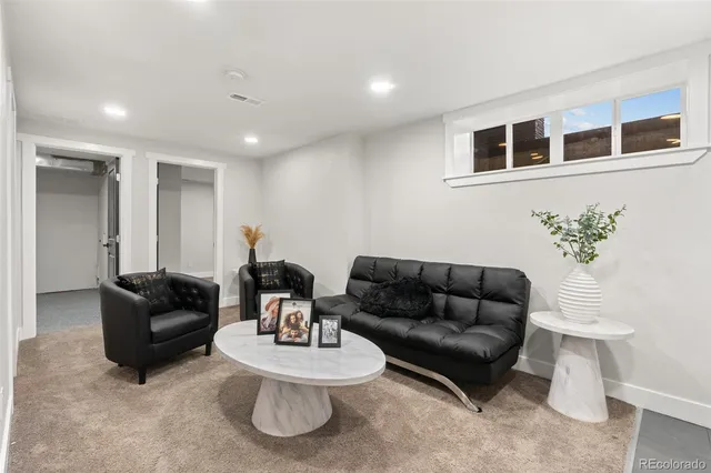 a living room with furniture and a potted plant