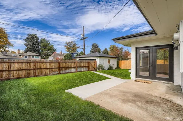 a view of a porch and yard in front of it