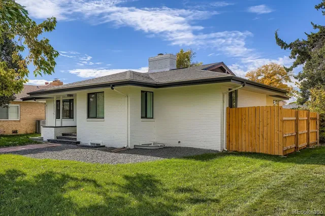 a view of a house with backyard and sitting area