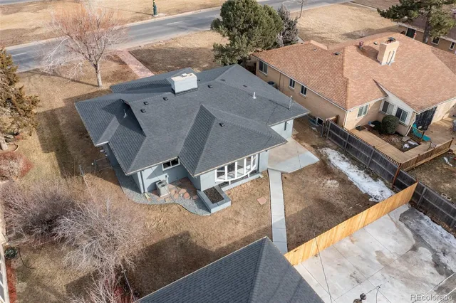 an aerial view of a house with a backyard