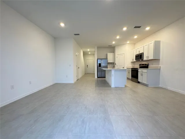 a view of a kitchen with a sink and a stove top oven