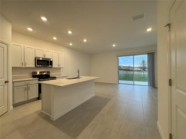 a kitchen with a sink stainless steel appliances and cabinets