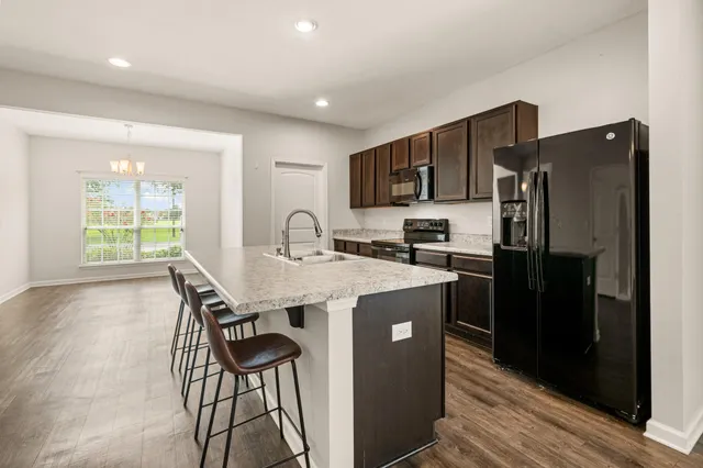 a kitchen with stainless steel appliances a sink stove and refrigerator