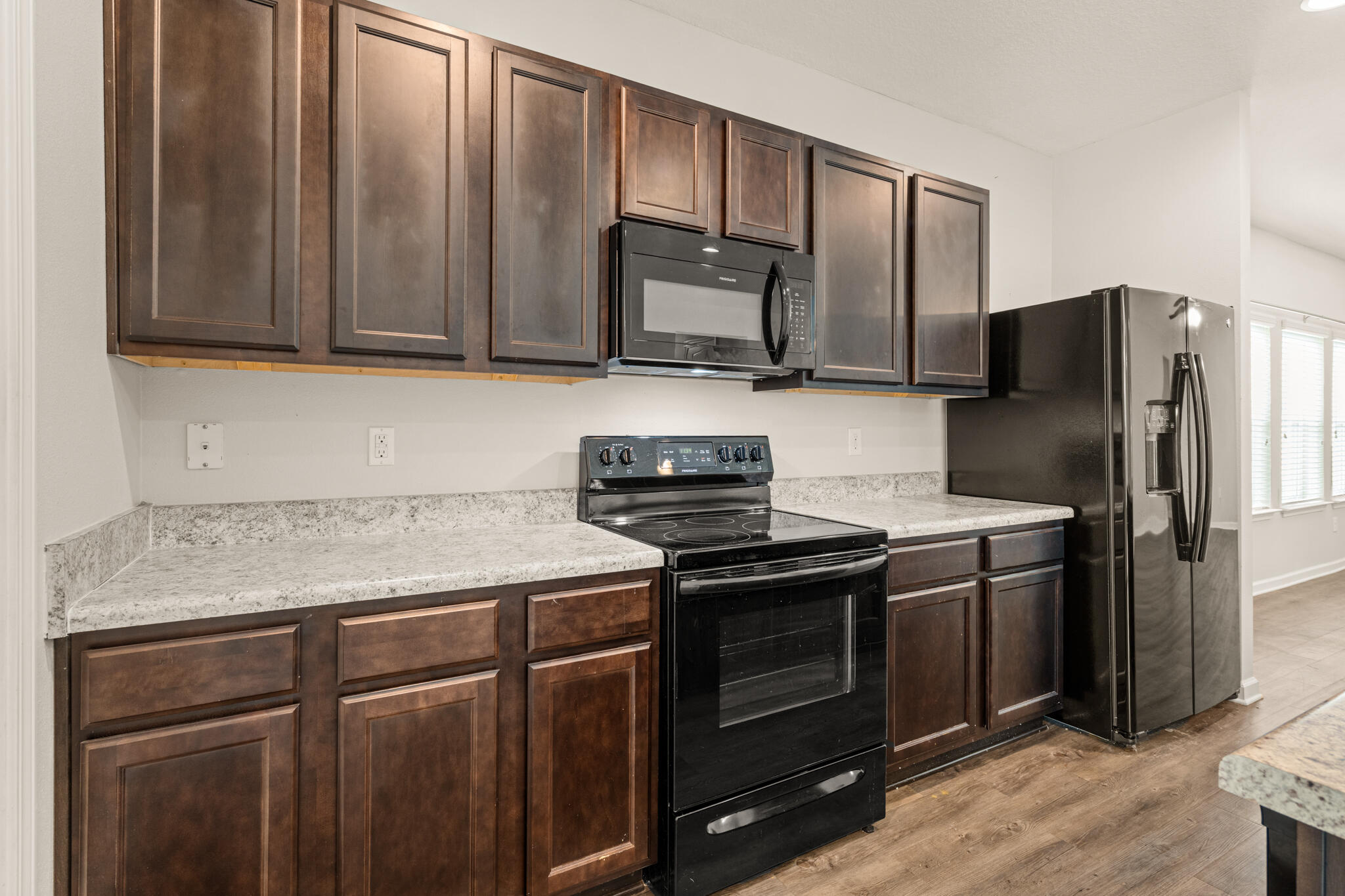 268 Cornelia Street Freeport, FL 32439 - Photo 13 of 41 a kitchen with granite countertop stainless steel appliances and wooden cabinets