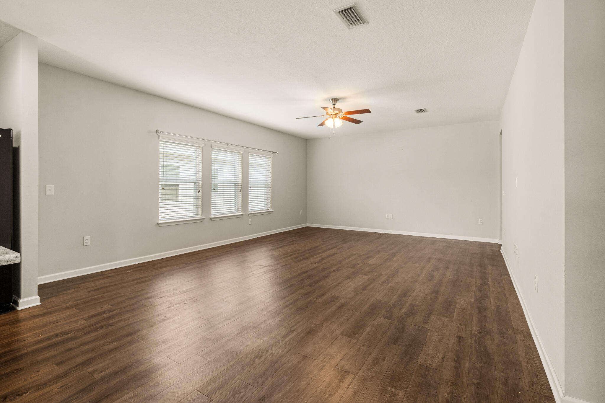 268 Cornelia Street Freeport, FL 32439 - Photo 14 of 41 an empty room with wooden floor and windows