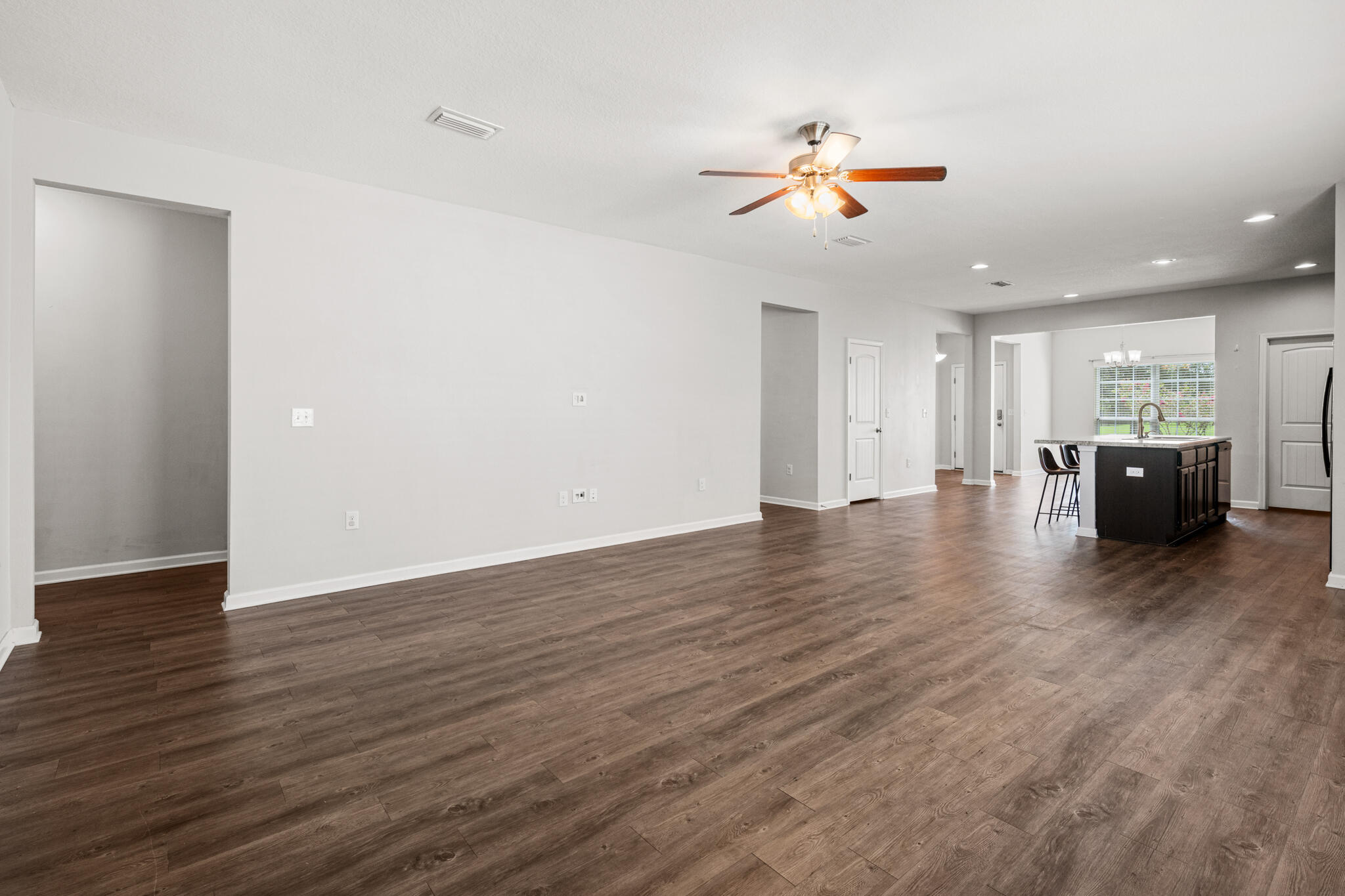 268 Cornelia Street Freeport, FL 32439 - Photo 15 of 41 a view of an empty room with wooden floor and windows