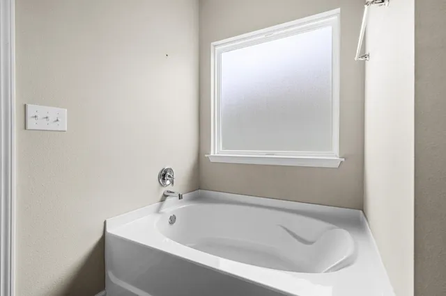 a white bath tub sitting next to a window
