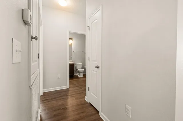 a view of a room with wooden floor