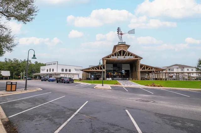 a view of a swimming pool with lawn chairs and a fire pit