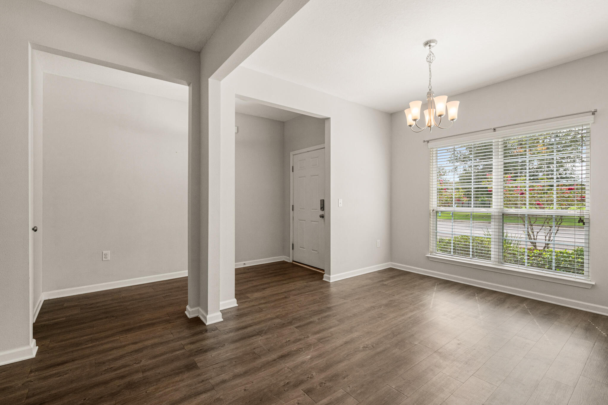 268 Cornelia Street Freeport, FL 32439 - Photo 7 of 41 an empty room with wooden floor and large windows