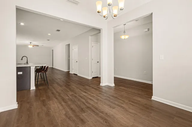 a view of a livingroom with a furniture wooden floor and a chandelier