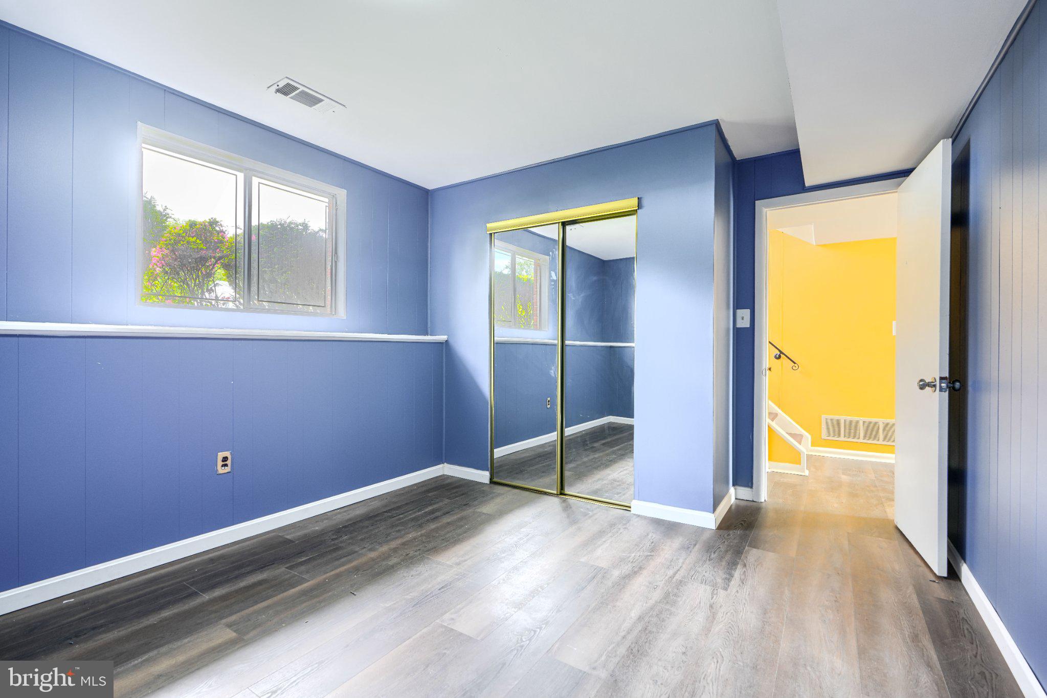 3910 Carthage Road Randallstown, MD 21133 - Photo 38 of 42 Bright and airy blue room with mirrors.