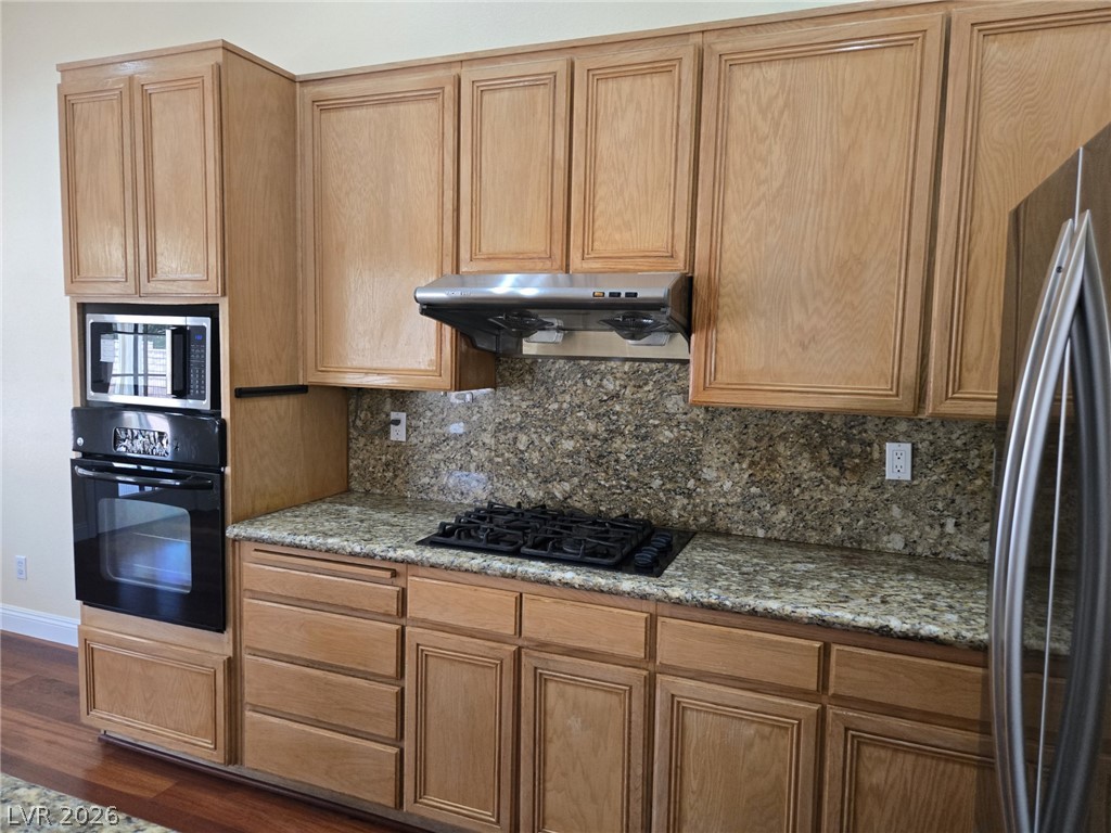 8417 San Ramon Drive Las Vegas, NV 89147 - Photo 15 of 33 A well-appointed kitchen features rich wood cabinetry and ample counter space for culinary endeavors.