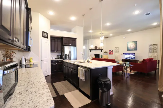 a large kitchen with kitchen island a sink table and chairs