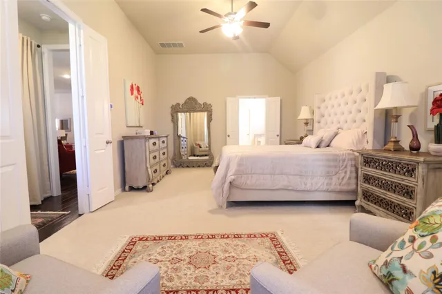 a bedroom with a bed and ceiling fan