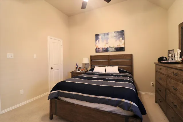 a bedroom with a bed and lamp