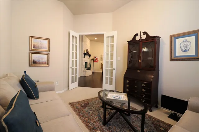 a living room with furniture and a dresser