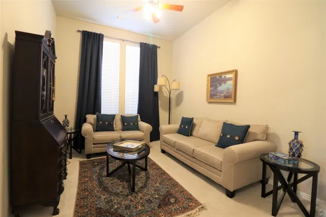 a living room with furniture a large window and a flat screen tv