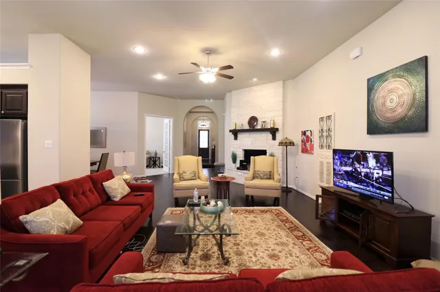 a living room with furniture dining area and a flat screen tv