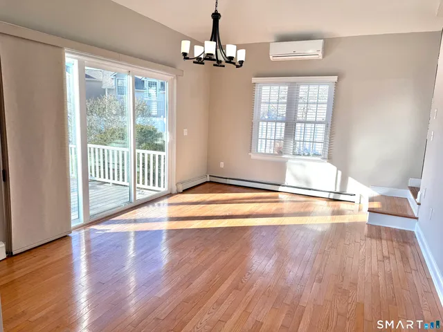 a large kitchen with cabinets and wooden floor