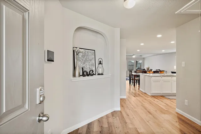 a view of a living room and kitchen with wooden floor
