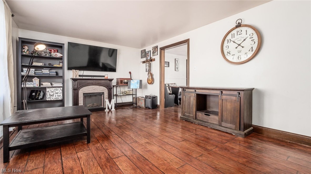 1730 Mollies Rock Road Dresden, OH 43821 - Photo 2 of 24 Living room with dark hardwood / wood-style flooring and a fireplace