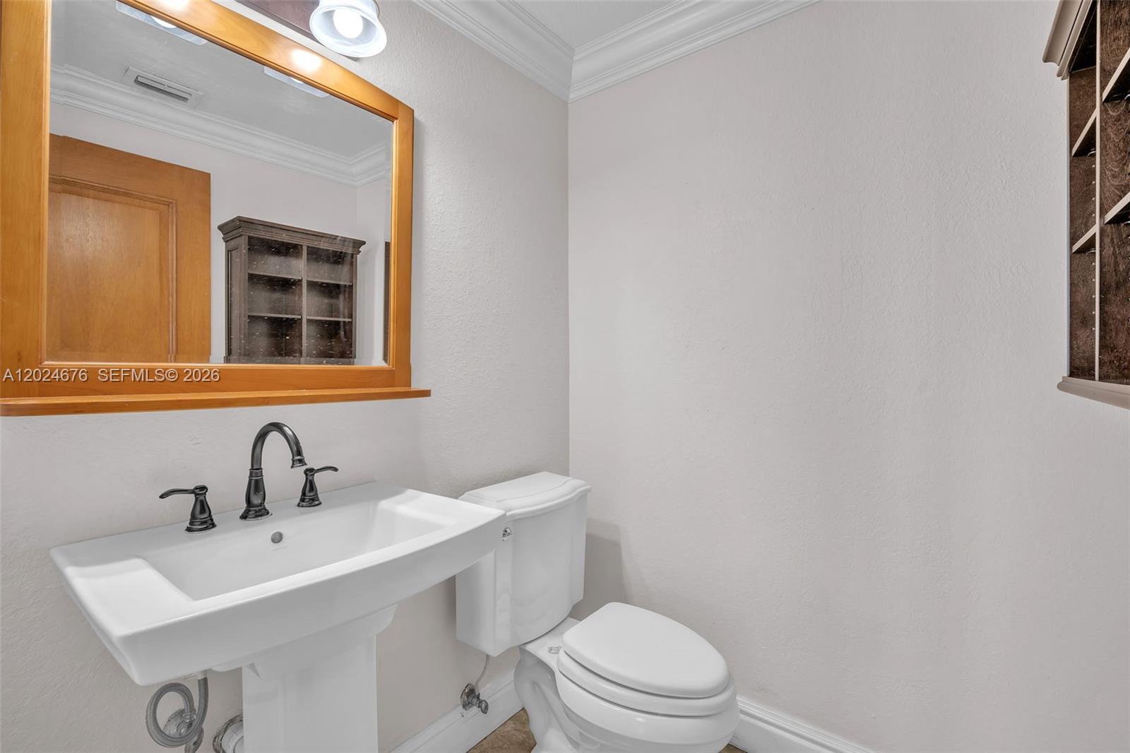 2155 Southwest 156th Court Miami, FL 33185 - Photo 30 of 57 a bathroom with a sink a toilet and mirror
